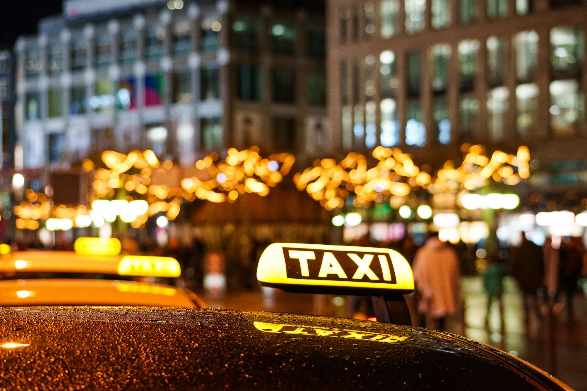 Lit taxi roof sign at night